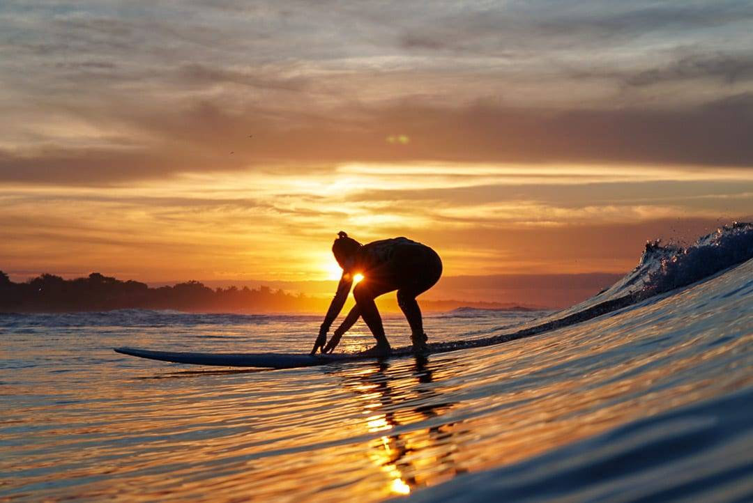 Surfing at sunset.